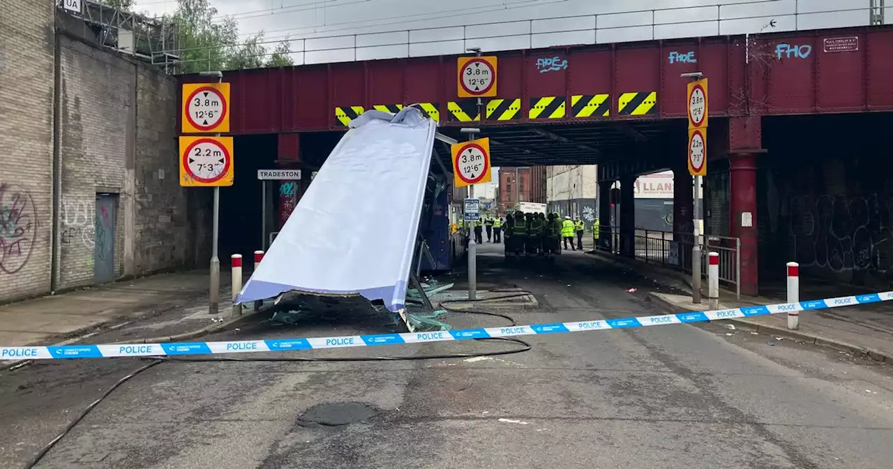 Roof sliced off Glasgow double decker bus in railway bridge crash