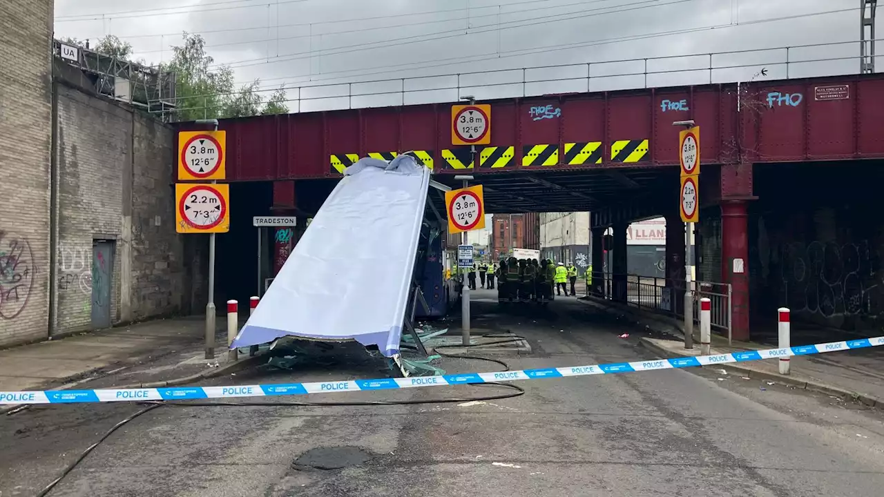 Three in hospital as bus loses roof after hitting railway bridge in Glasgow