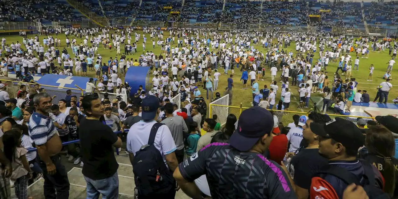 Angry fans crash through gate at El Salvador soccer match in stampede that kills 12, injures dozens