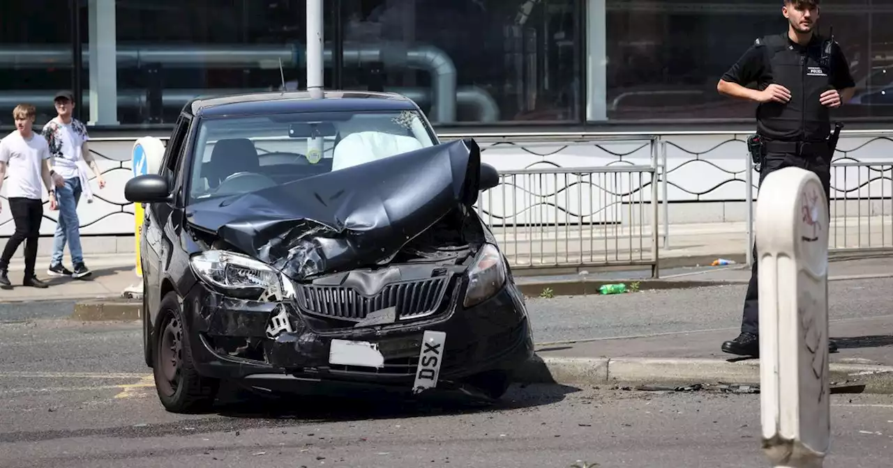 Road blocked in Manchester city centre as car left crushed in smash