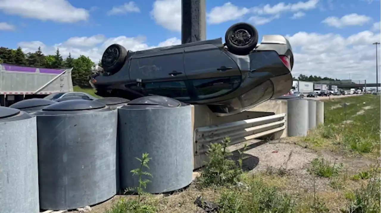 Two people taken to hospital after car flips onto guardrail on Highway 410