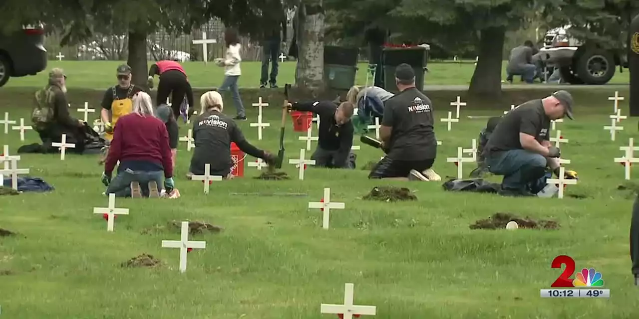 Paying respect to the fallen by cleaning their gravestones