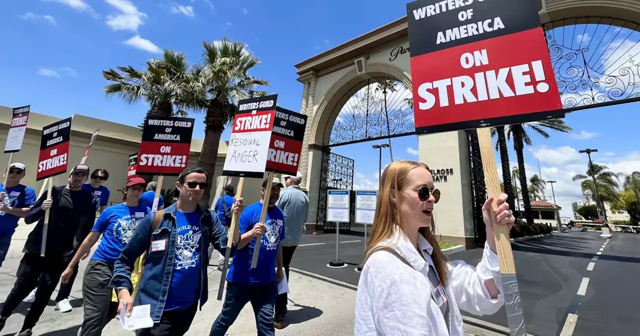 Writers' strike: Hollywood scribes picket studios for better pay. 'It's not sustainable'