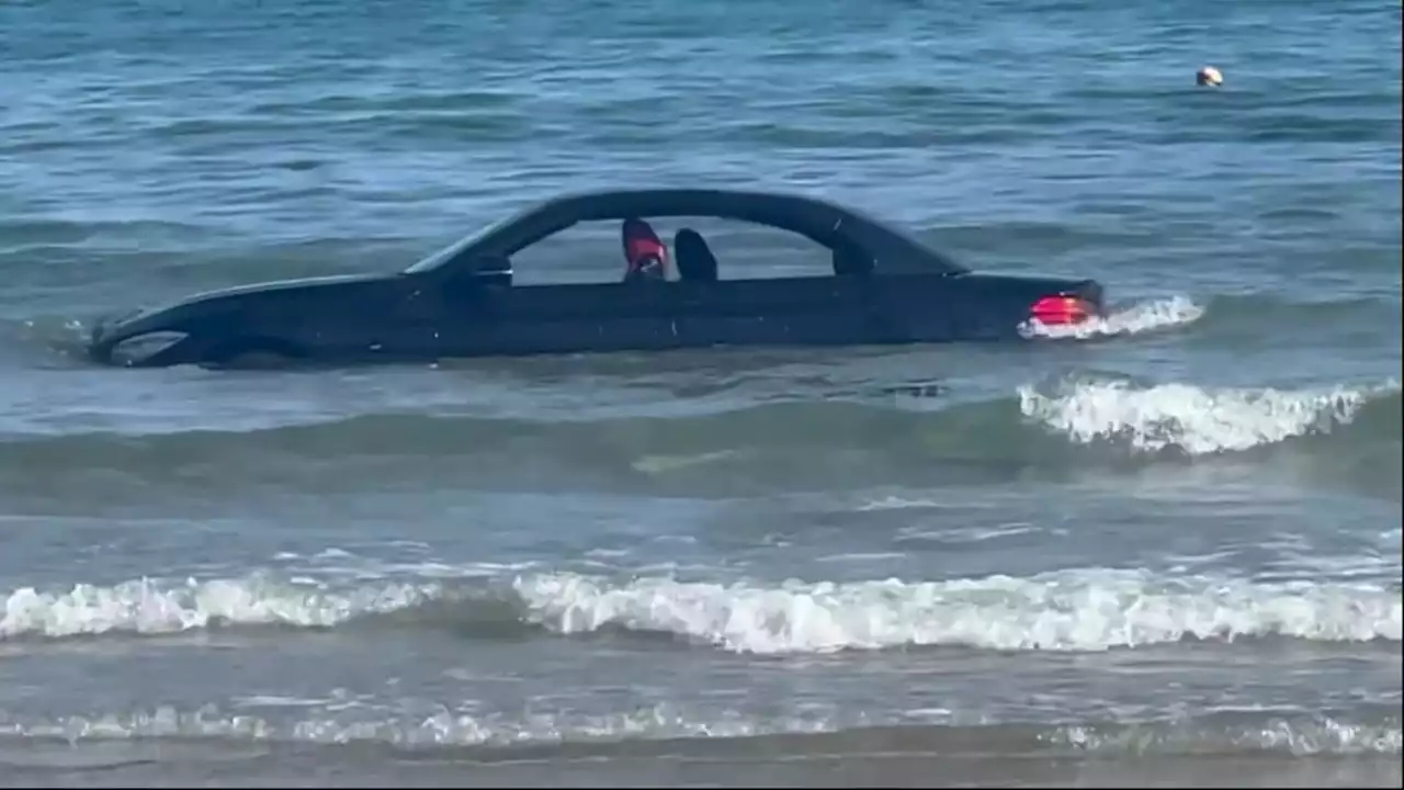 Convertible BMW gets washed out to sea after parking on UK beach