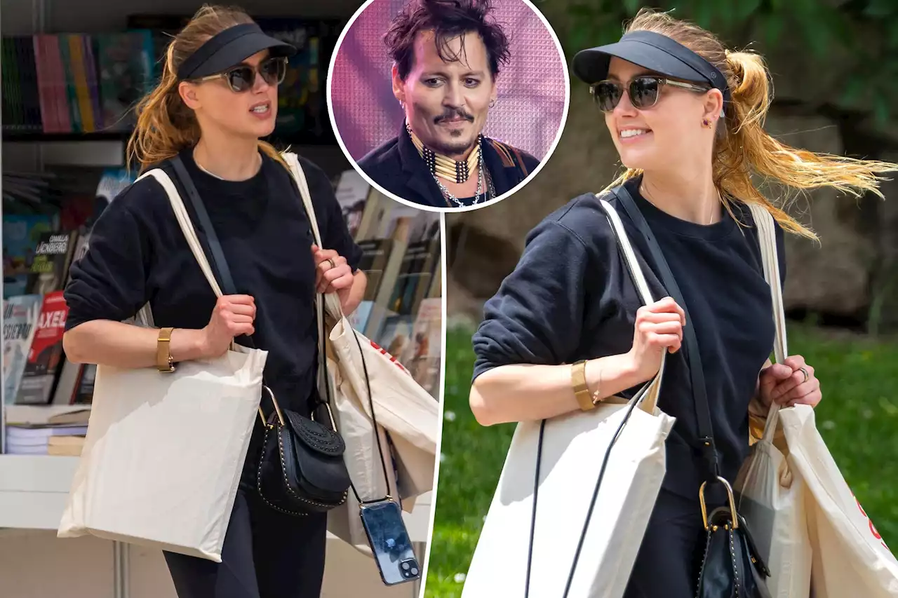 Amber Heard beams in new home Madrid as ex Johnny Depp cancels tour over injury