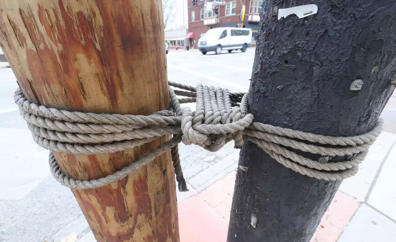 Why is an old, ugly utility pole tied to a brand new one?