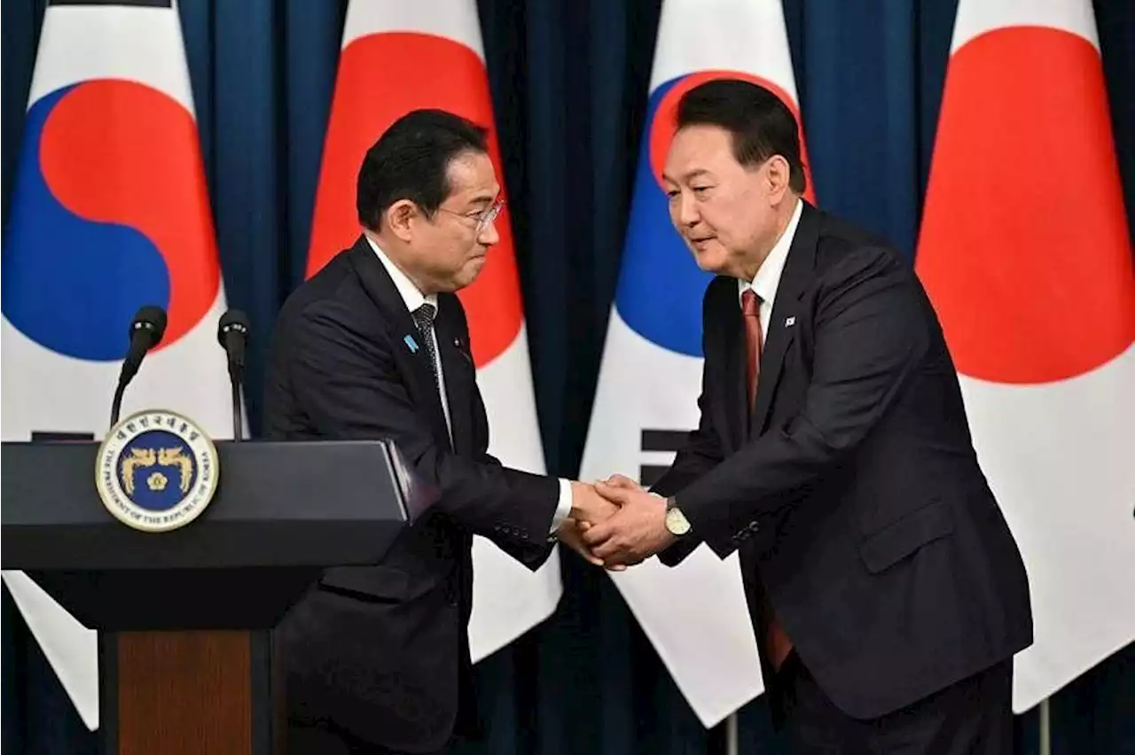 Japan PM applauds trust with South Korea after landmark summit