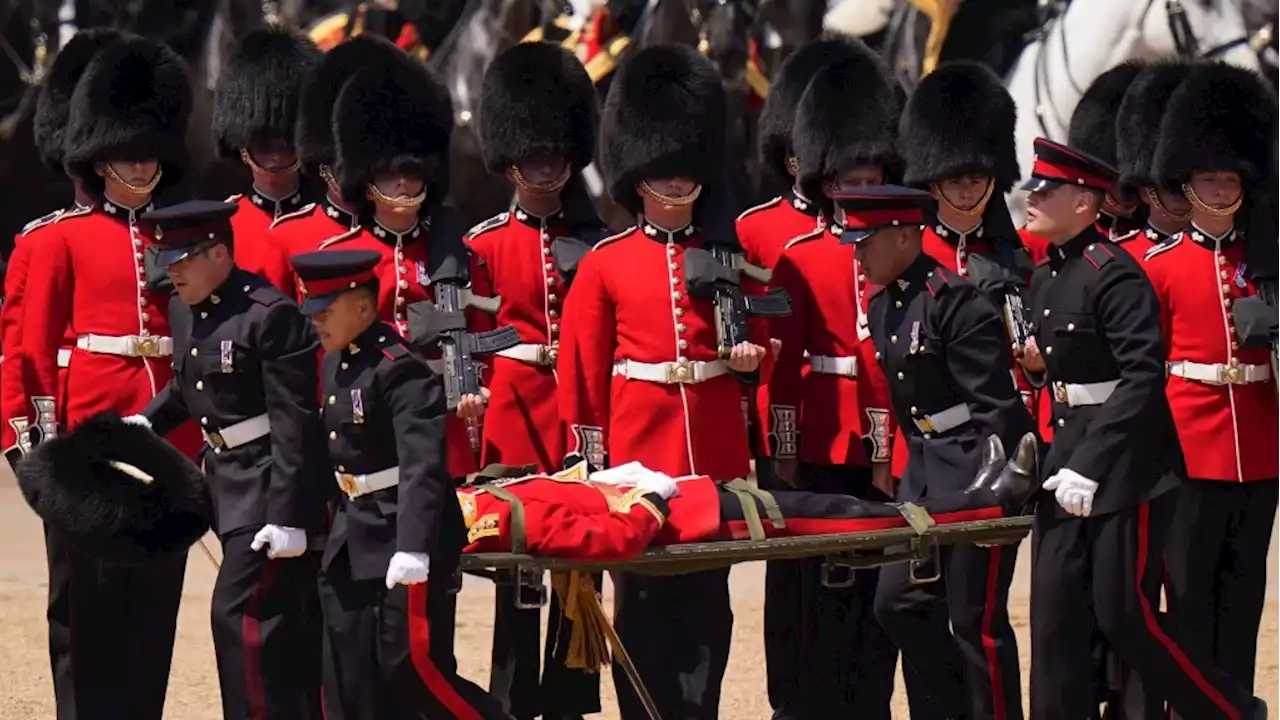 Troops feel the heat, and several faint, as Prince William reviews military parade