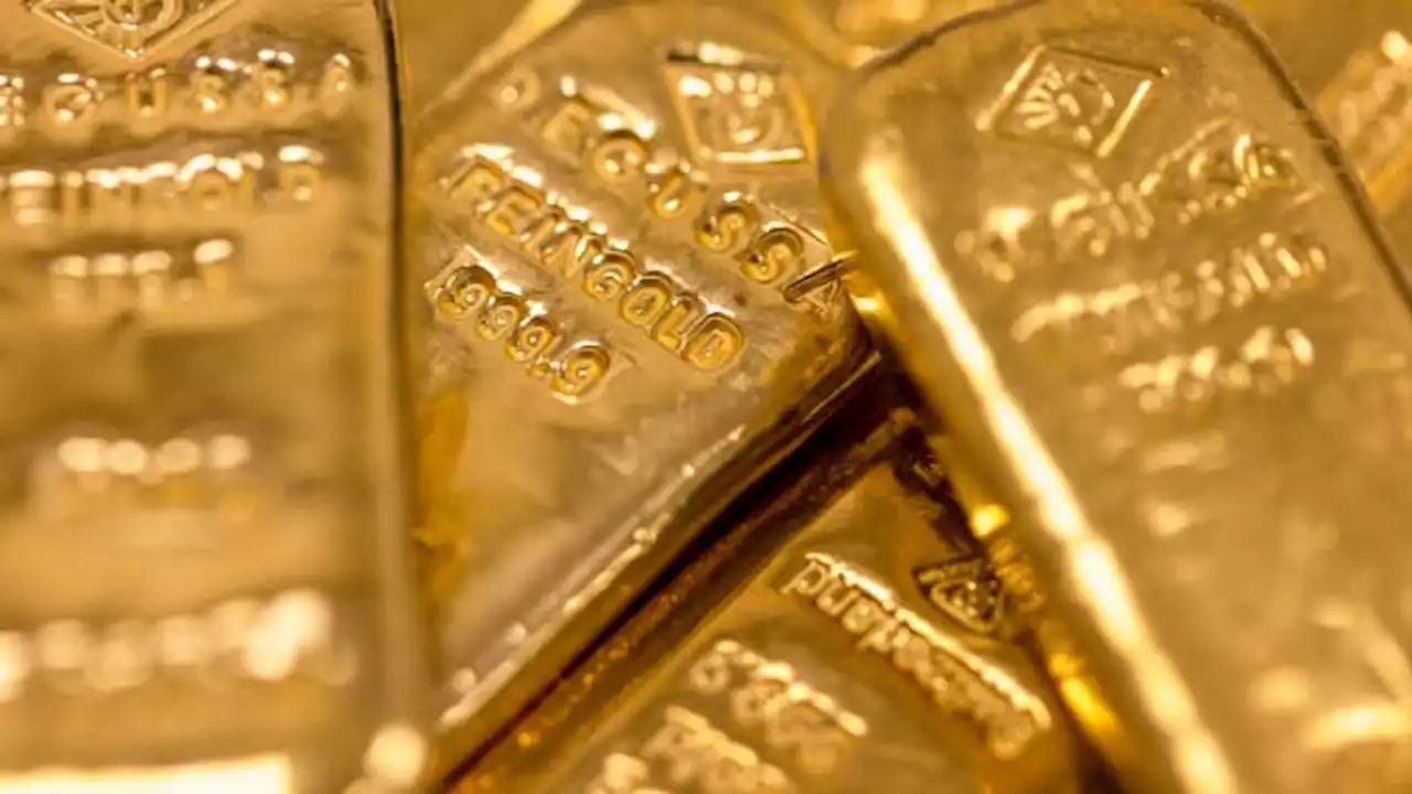 Gold eases on stronger dollar, focus on central bank meetings