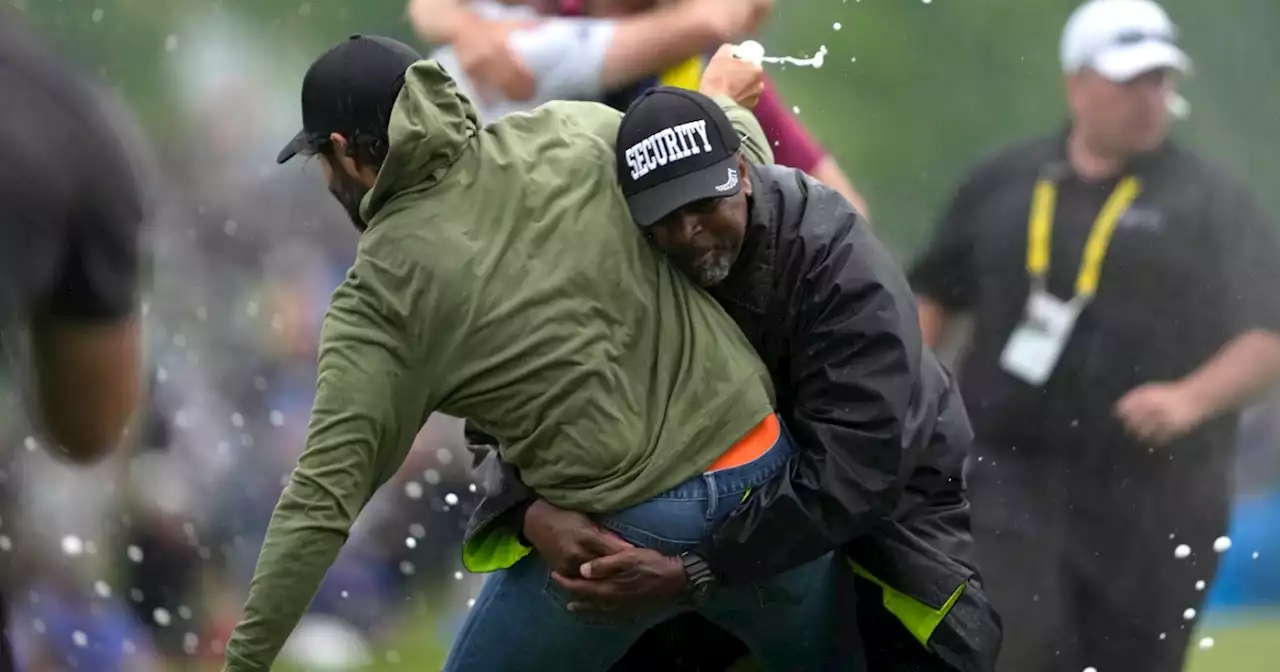 Canadian golfer gets tackled by security while celebrating fellow golfer's tournament win