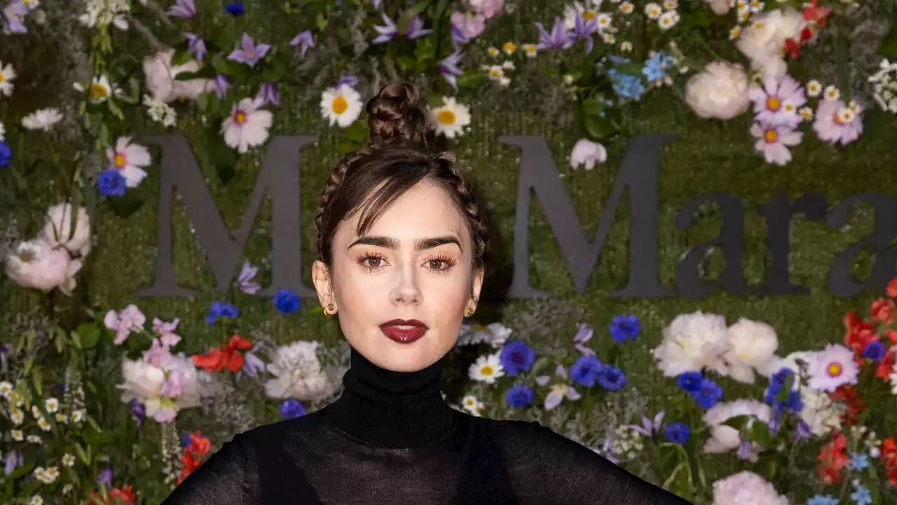 Lily Collins Embraces The Dark Side With Vampy Lips And A Plaited Up-Do