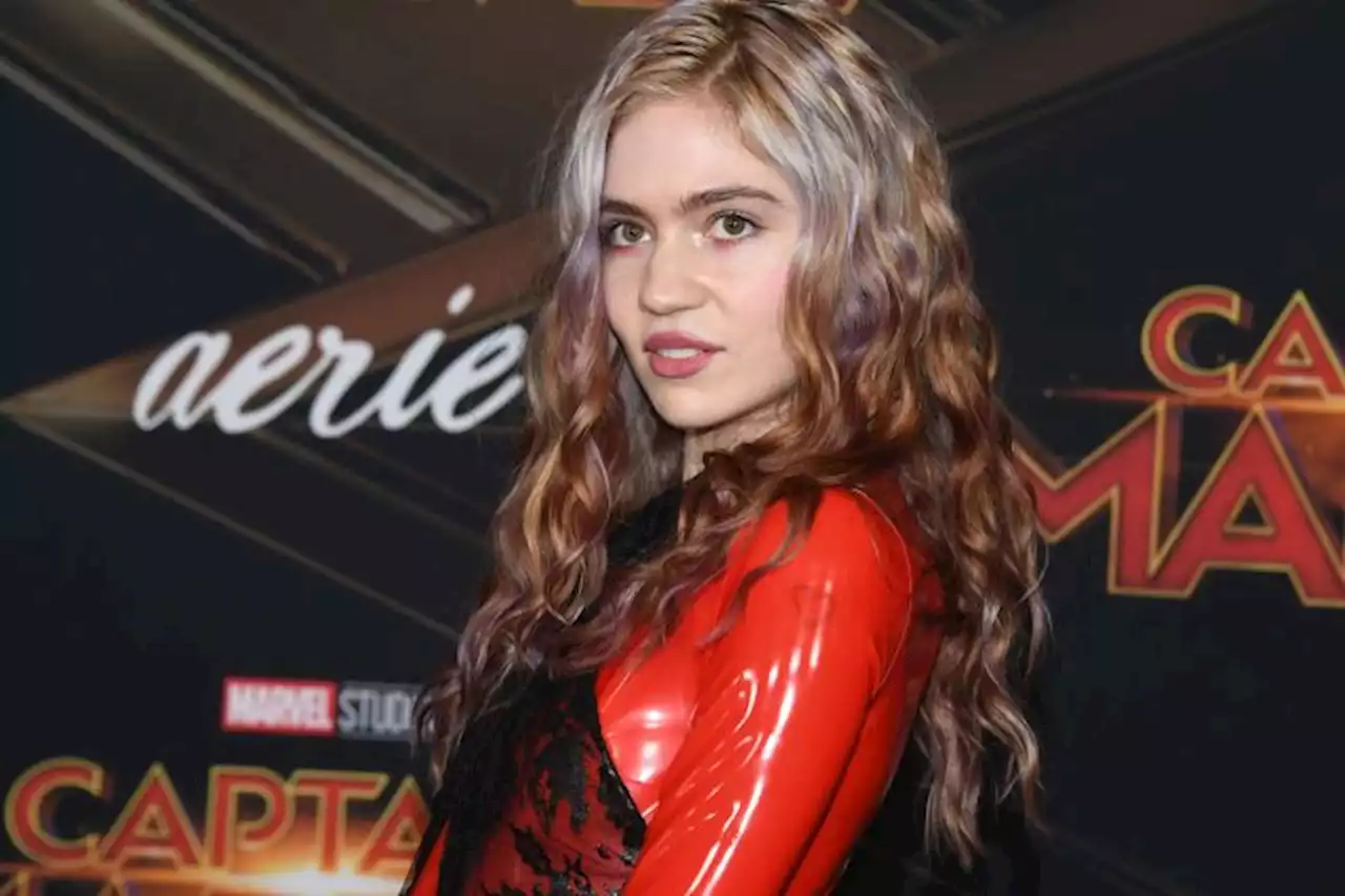 Grimes Unveils ‘Alien Scar’ Chest Tattoo, Gives Fans Another Look At Huge Red Leg Inking