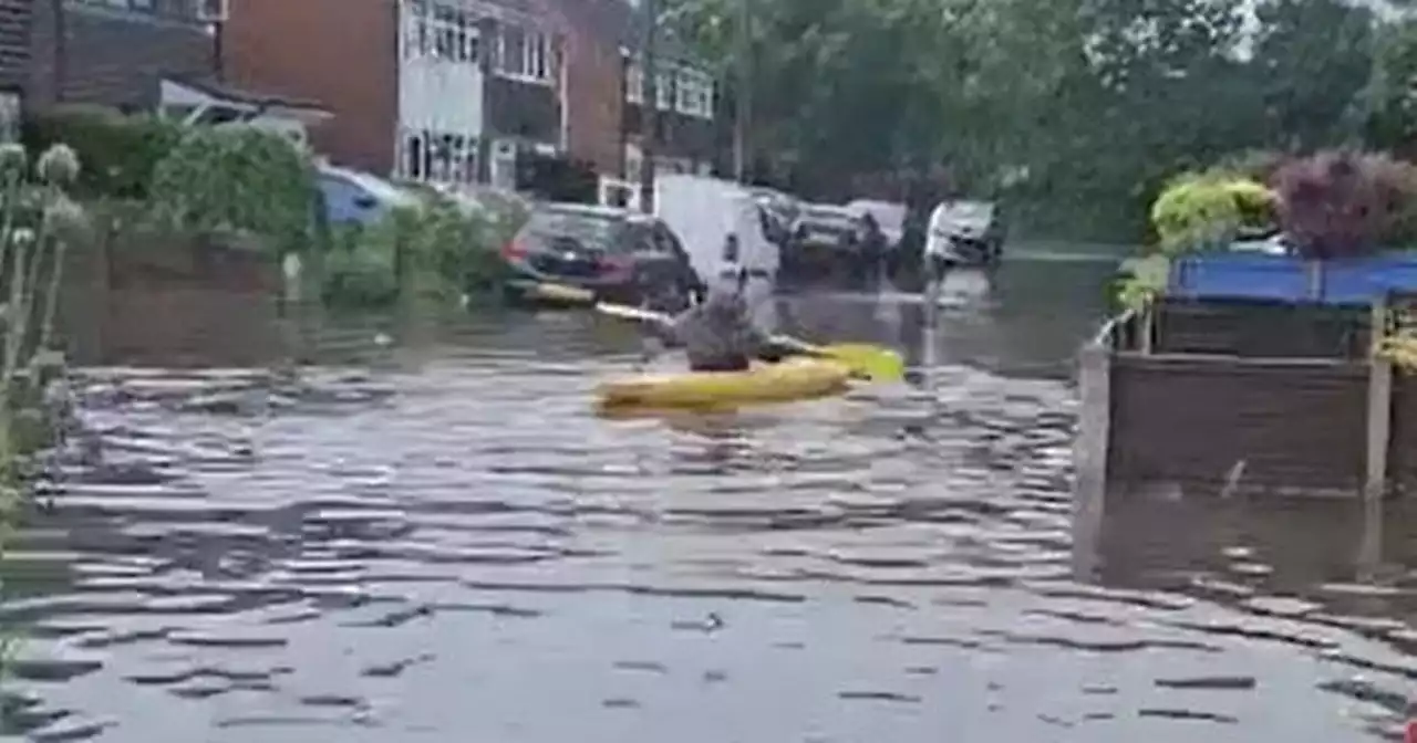 Halted Man City parade and man sailing down street in KAYAK amid another storm