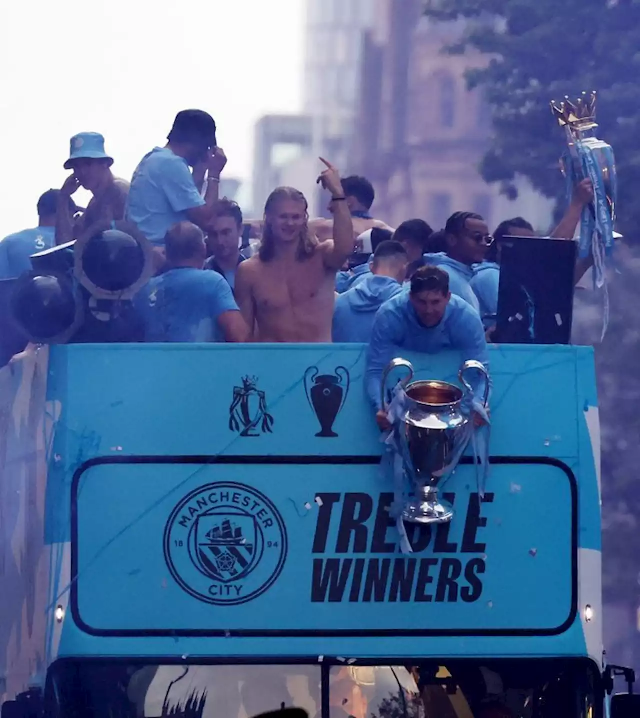 Soccer-Manchester City dance in the rain to celebrate treble