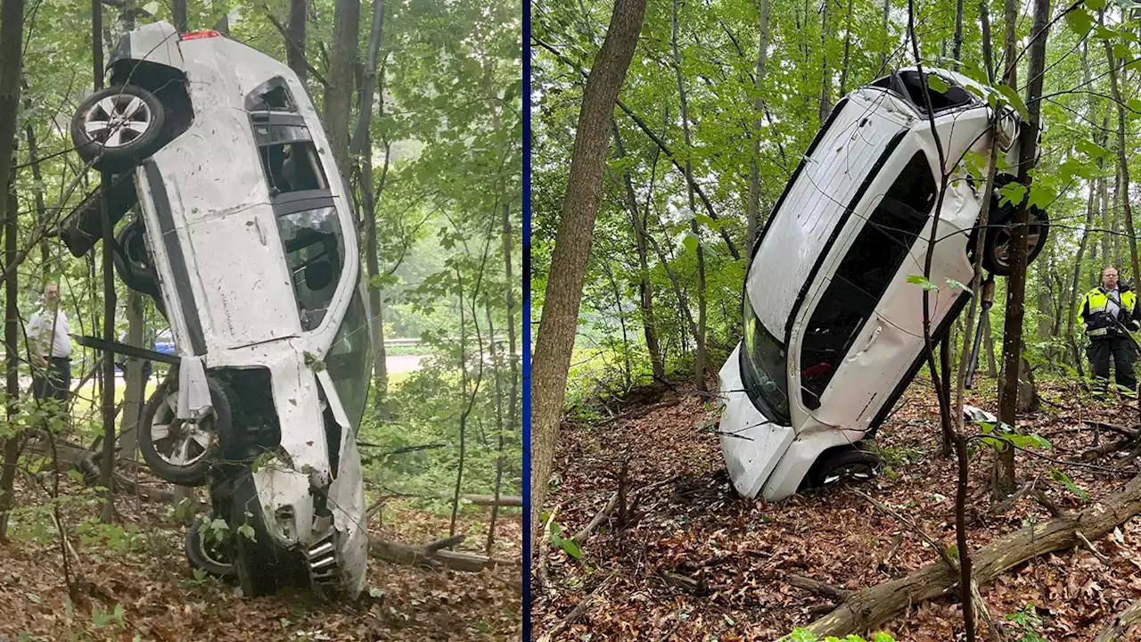 Crashed SUV lands balanced on its hood off I-495