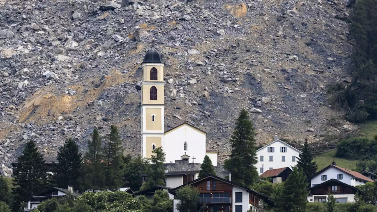 Mass of rock slides down mountainside above evacuated Swiss village, narrowly misses settlement