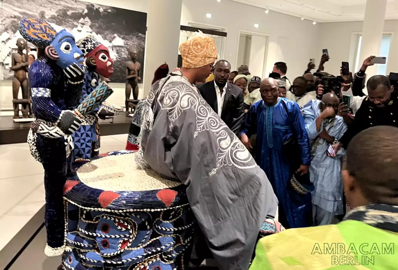 African king visiting European museum sits on throne taken from ancestor