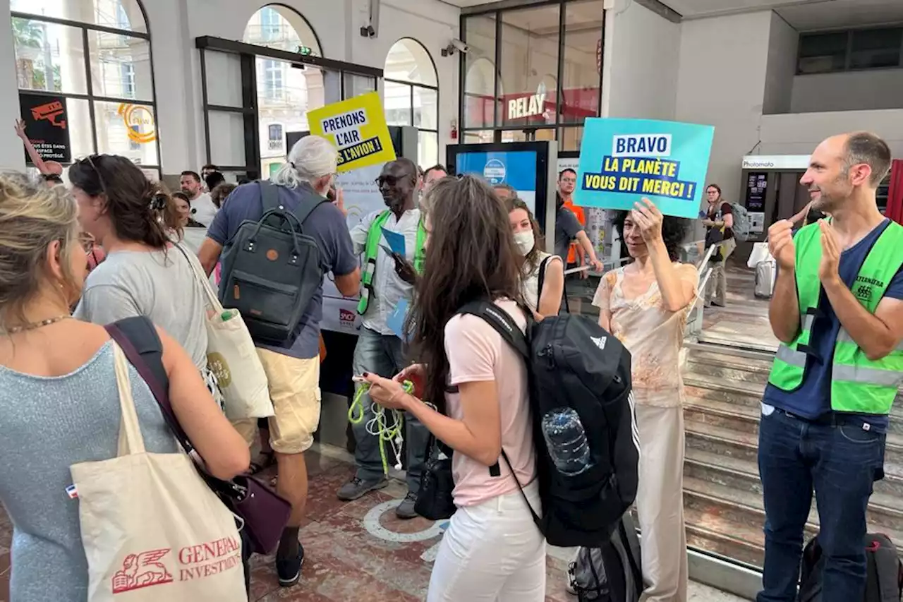 Applaudis pour avoir pris le train, des voyageurs accueillis par Greenpeace à la gare de Montpellier