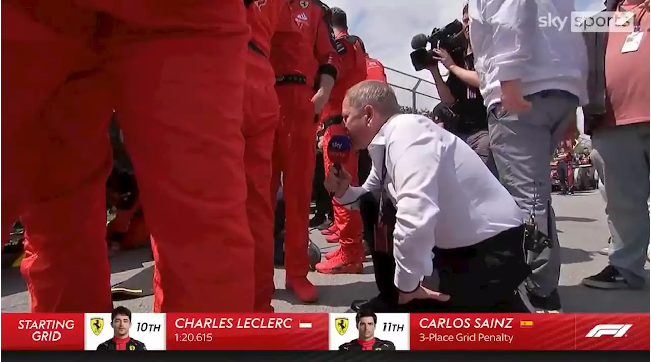 Martin Brundle can't be stopped as he peeks through angry Ferrari mechanics' legs