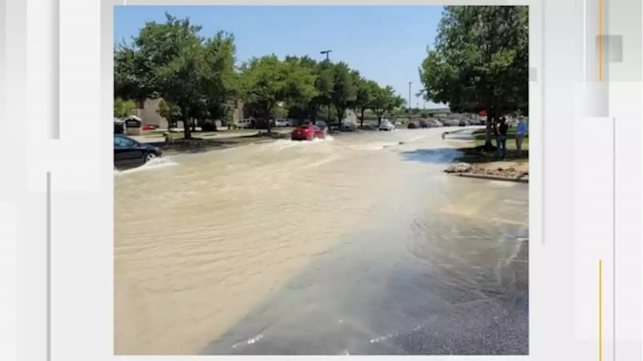 Water main break floods parking lot at The Rim, prompting some businesses to close