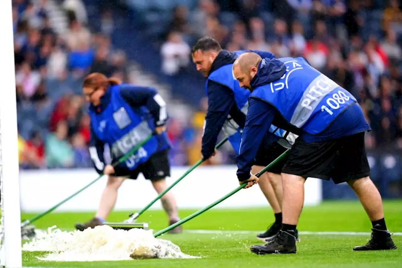 'Why does it always rain on me': Scotland fans burst into song as match suspended