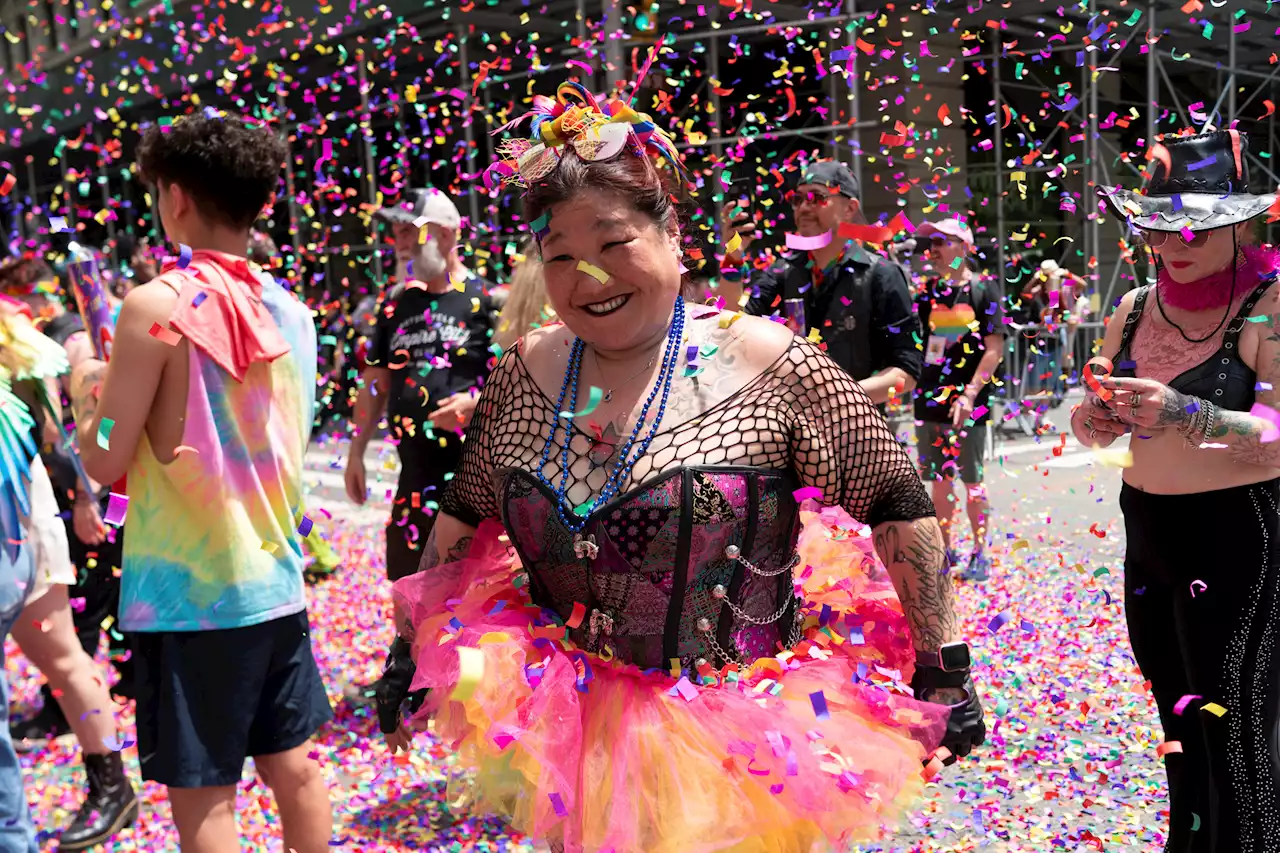 LGBTQ Pride revelers flash feathers and flags in the streets from New York to San Francisco