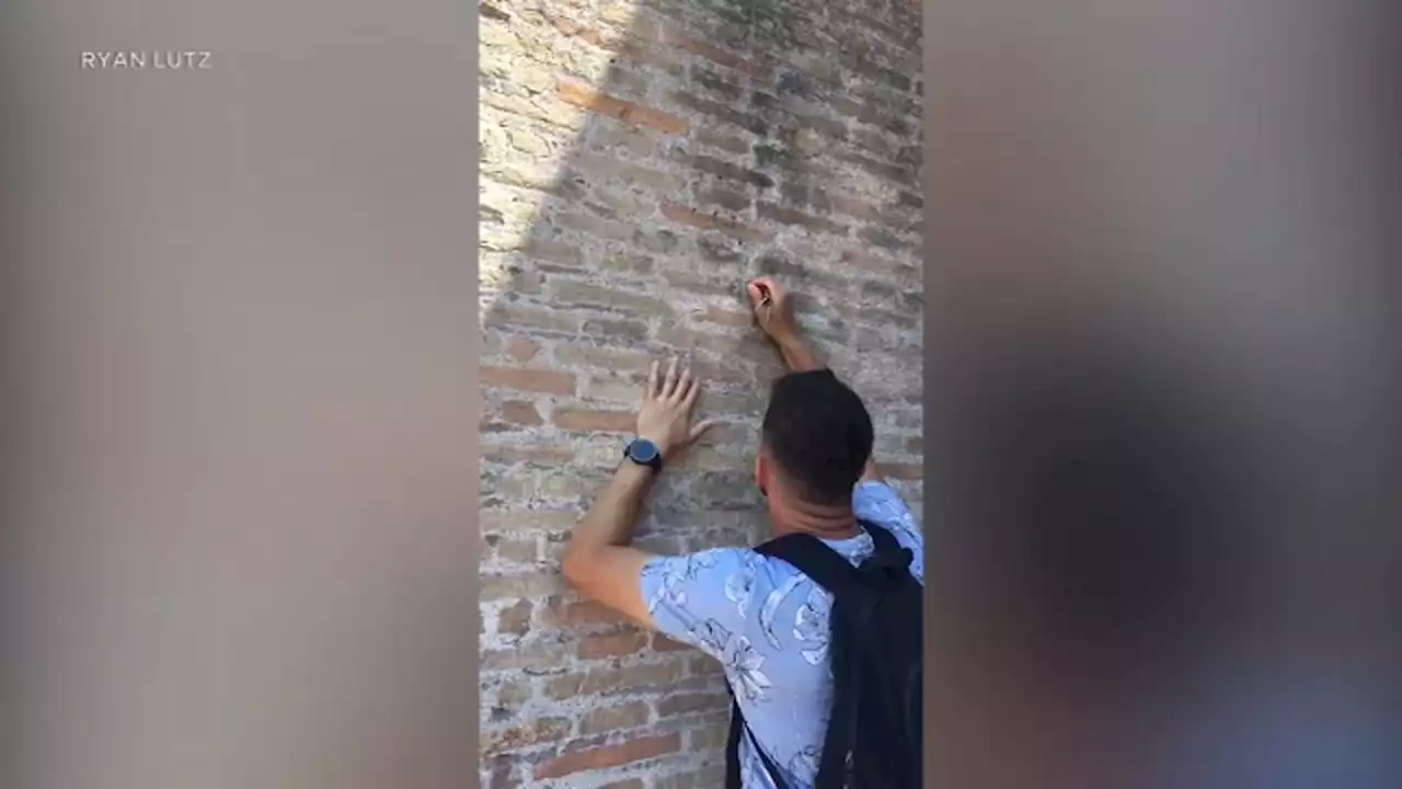 Italy officials vow to find and punish tourist filmed carving into Rome's Colosseum