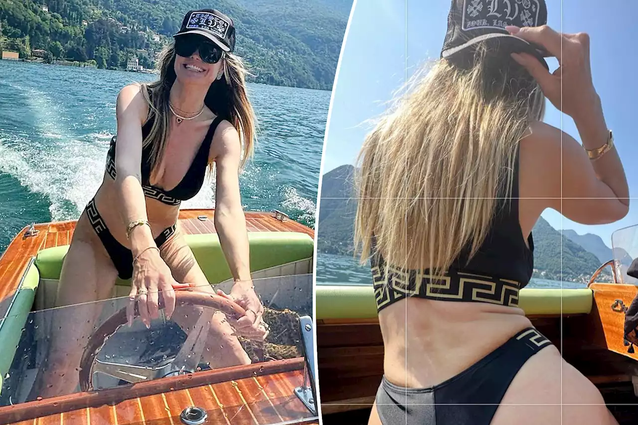 Heidi Klum gets cheeky in a Versace thong bikini while boating in Italy