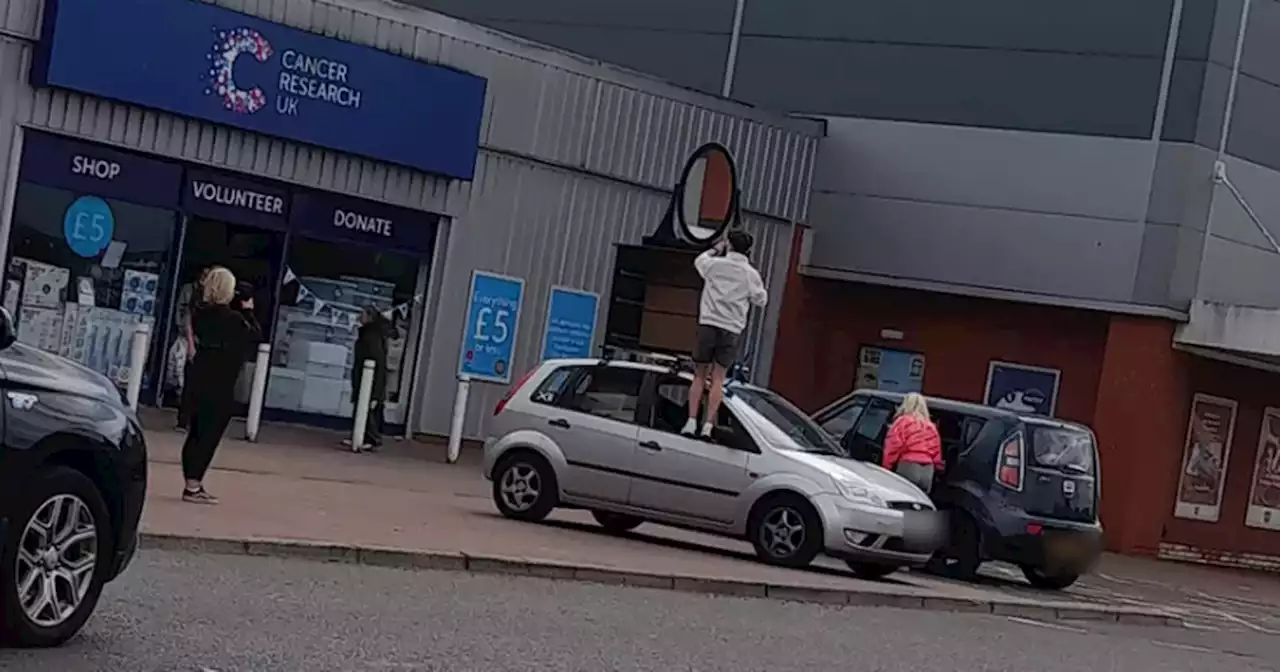 Scots shoppers baffled as man straps chest of drawers and mirror to car roof