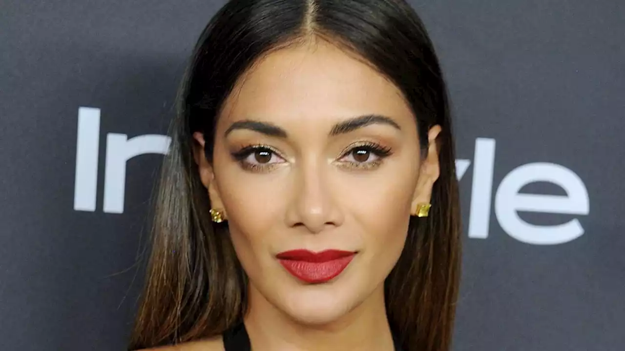 Nicole Scherzinger causes a stir as she poses in just a robe for sizzling video