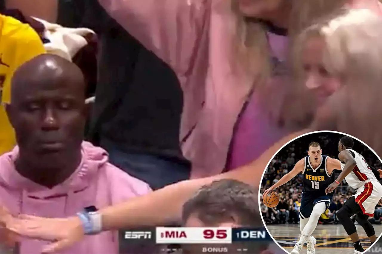 Terrell Davis looks absolutely miserable as surrounding Heat fans celebrate win over Nuggets