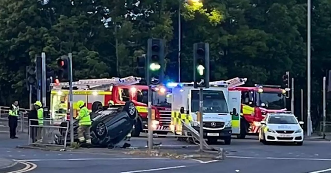 Man rushed to hospital as car flips onto roof after crash on busy Glasgow road