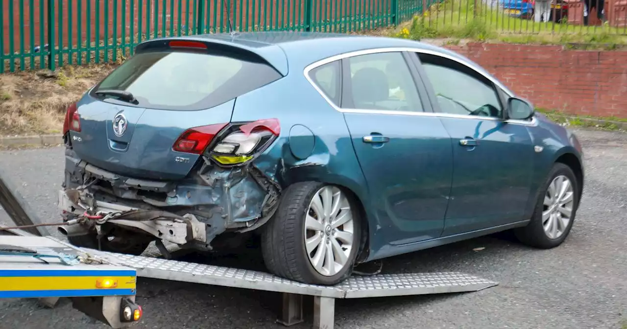 Car left smashed after driver 'reverses into police van' as road cordoned off