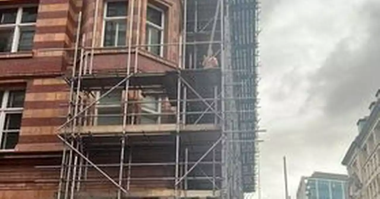 Police cordon off street in city centre after man climbs up scaffolding