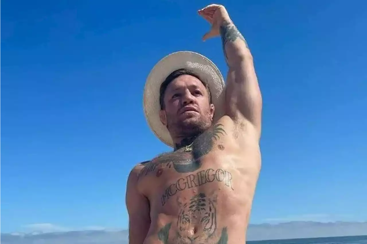 Conor McGregor gets in some stretching during family beach trip in Versace budgie smugglers