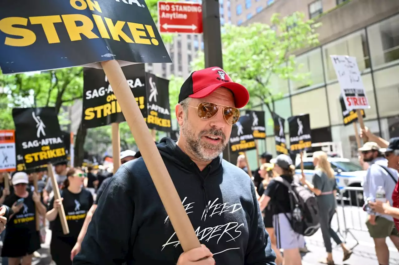 Hollywood stars join picket lines as actors' strike shuts down production on films and TV shows