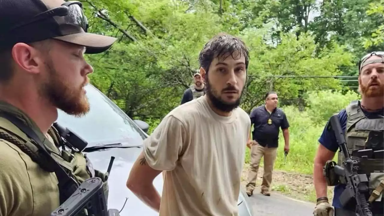 New photos show fugitive murder suspect Michael Burham during arrest 'at gunpoint'