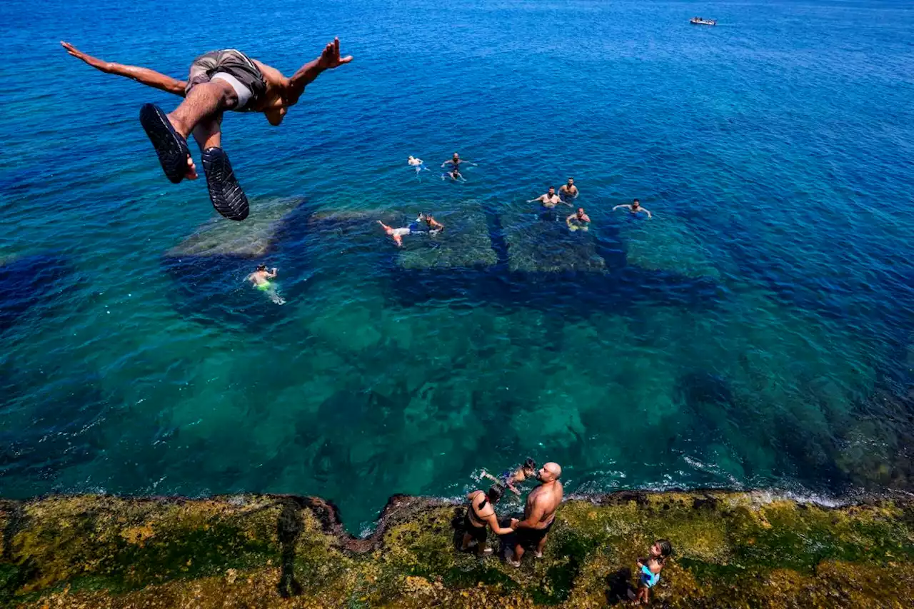 AP PHOTOS: Around the world, millions feel the heat of an unrelenting summer