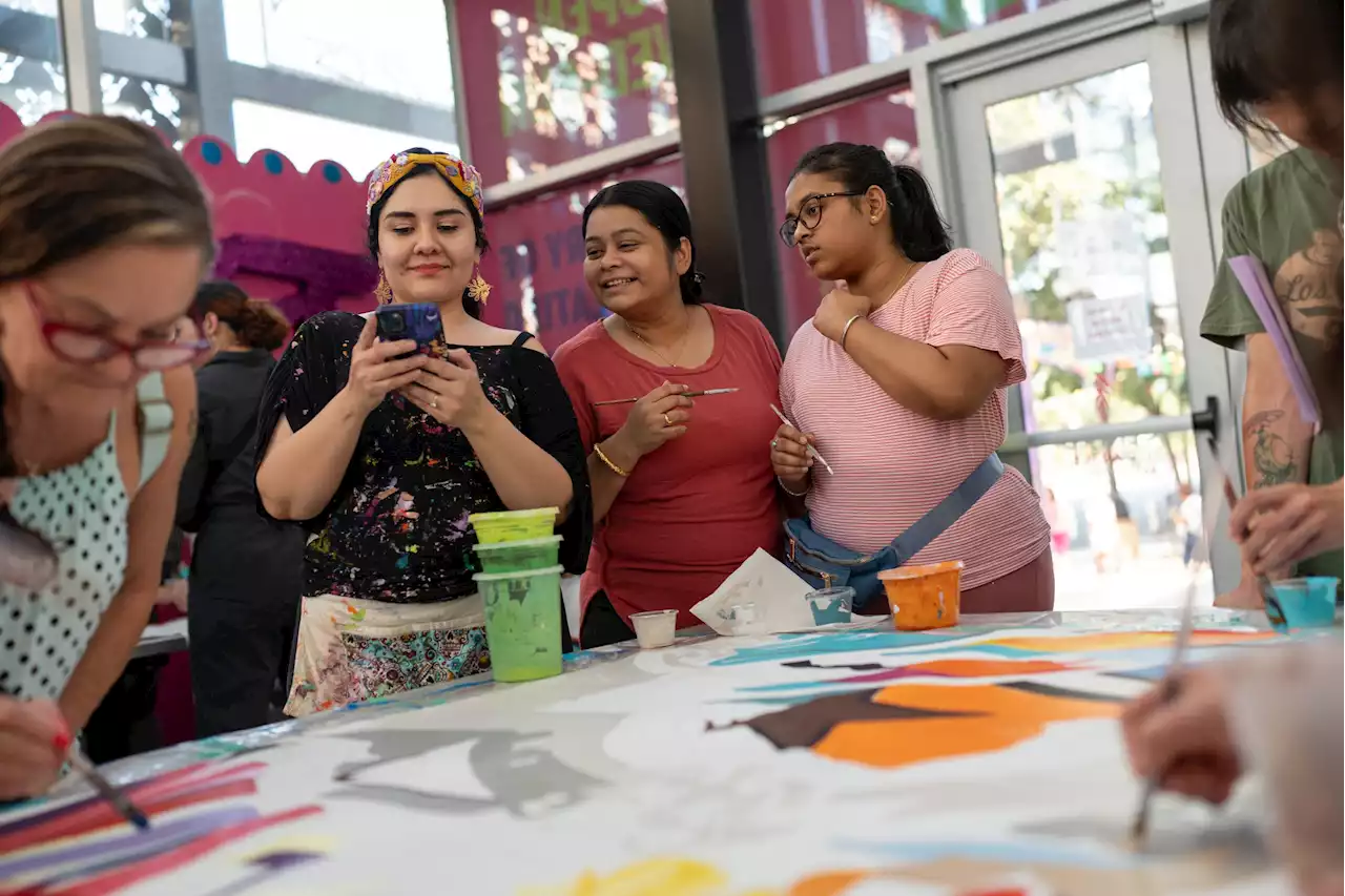 Families help paint airport mural of San Antonio's 'hidden treasures'