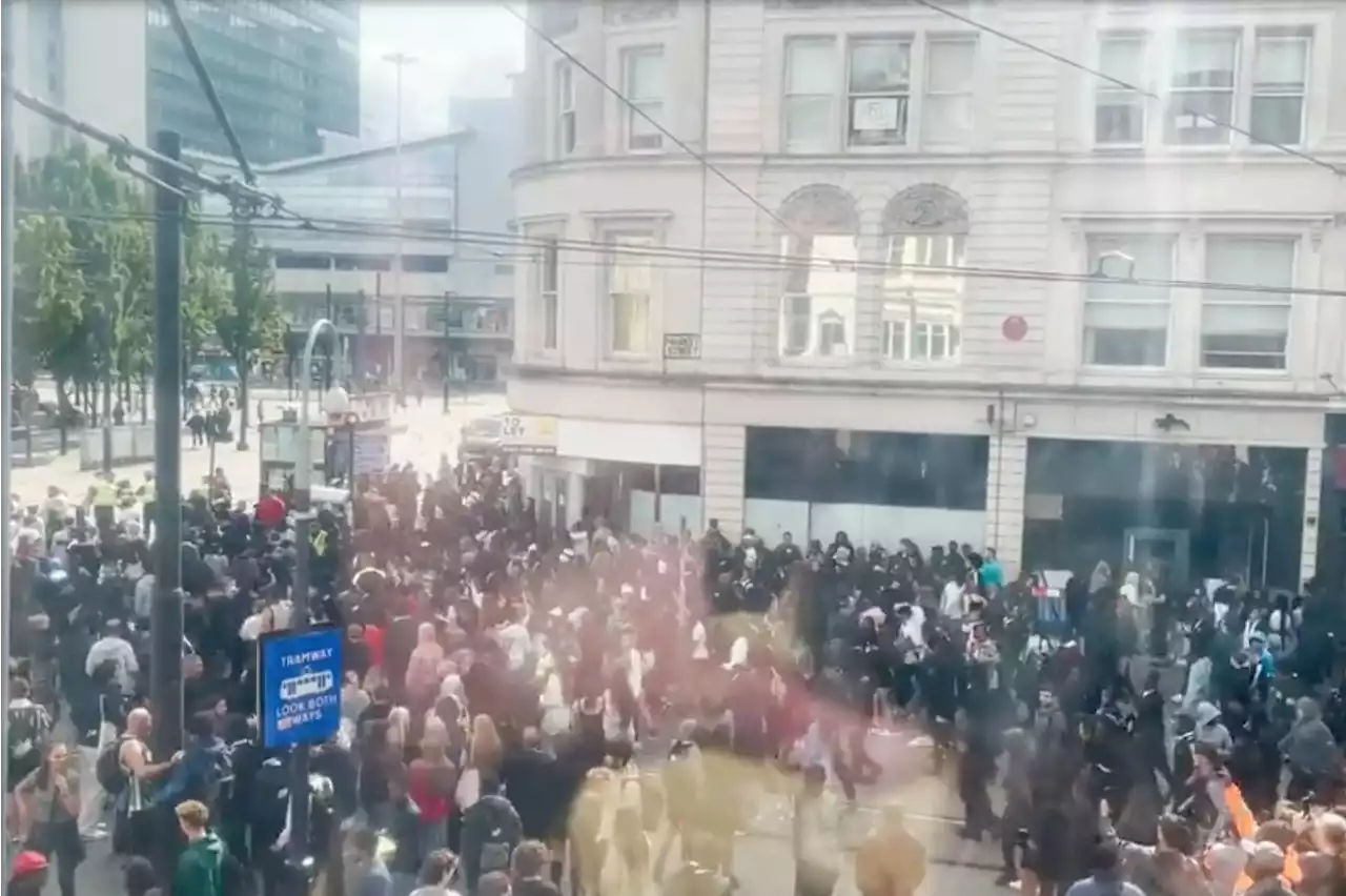 Shocking moment hundreds of school kids run riot in Manchester city centre as cops 'hit with eggs'