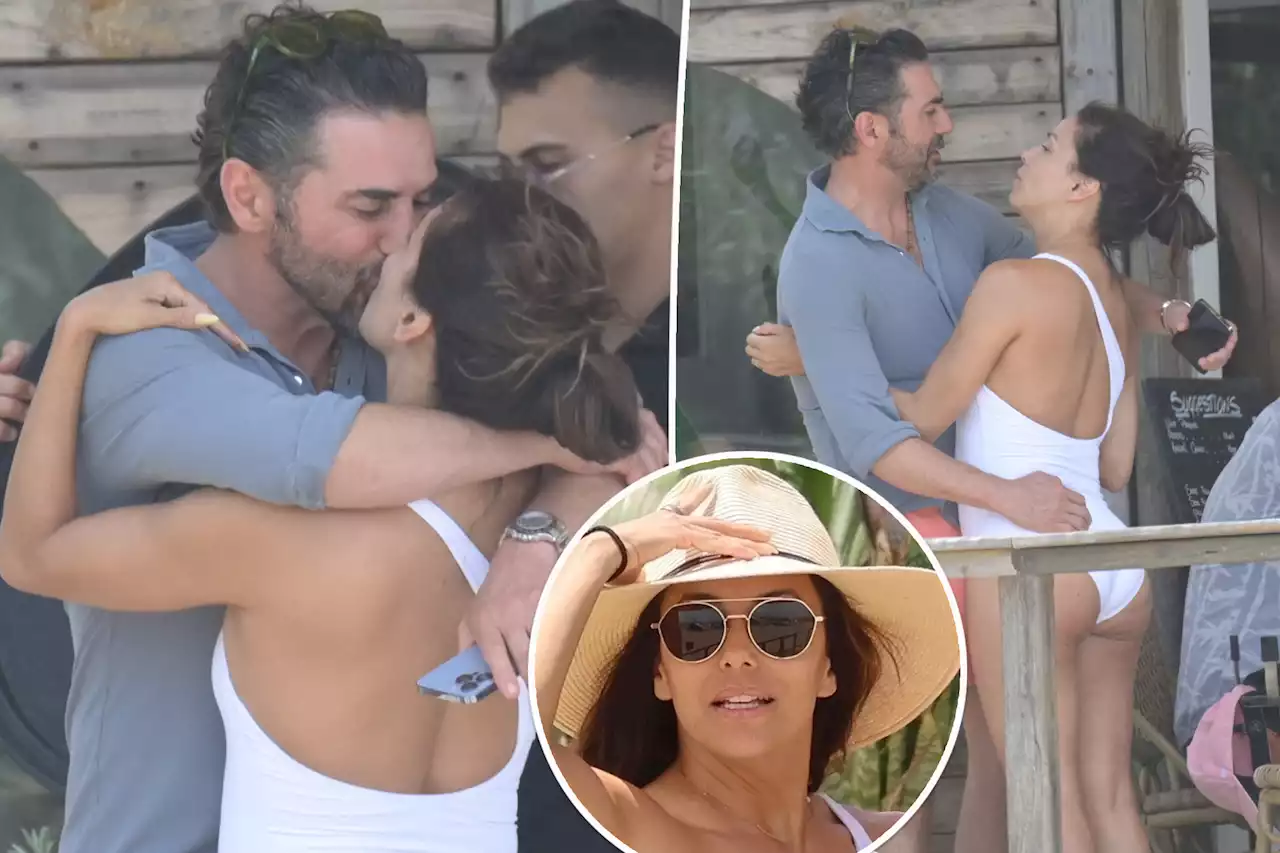 Eva Longoria affectionately kisses husband José Bastón while in a cheeky swimsuit