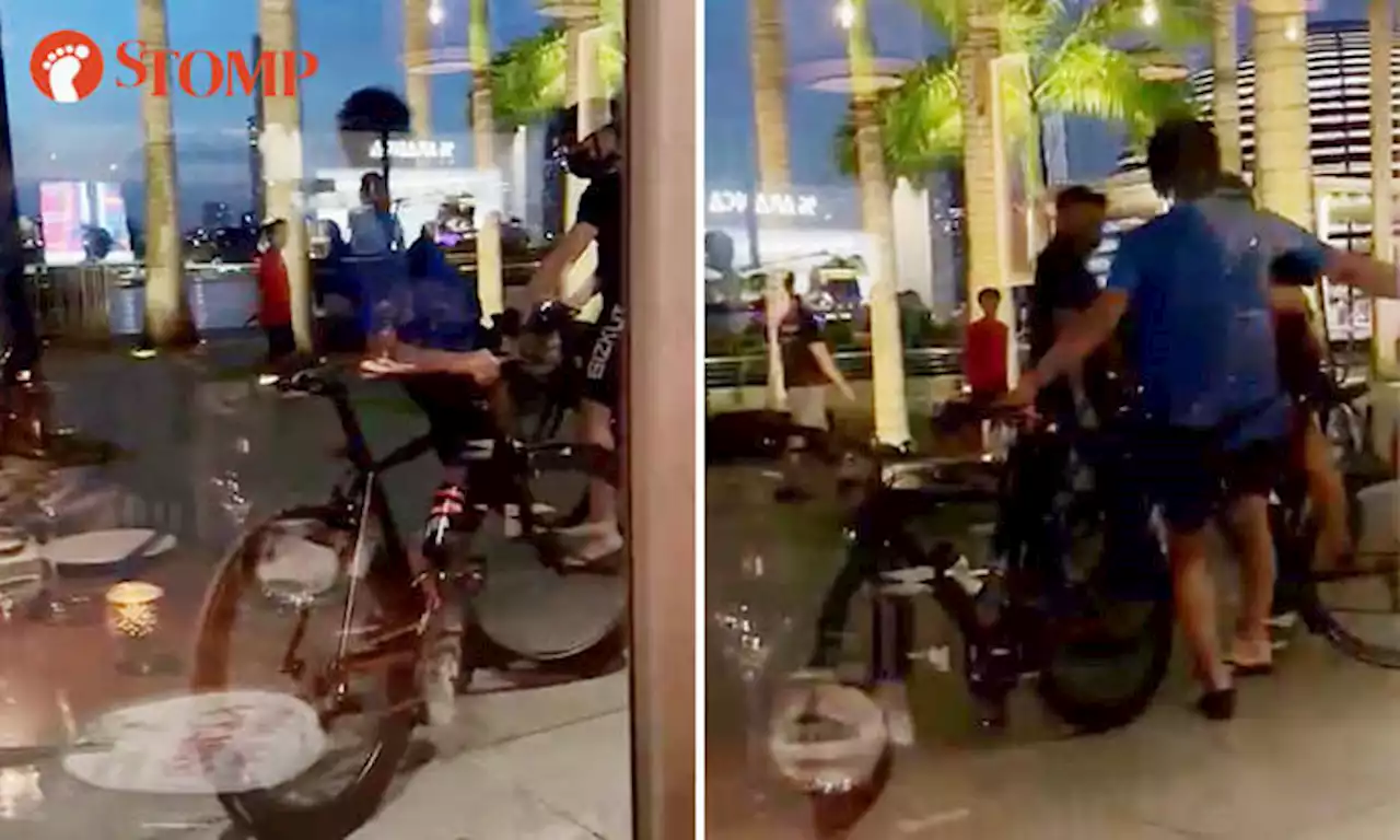 Man confronts another cyclist who overtook him outside MBS, repeatedly kicks his bike