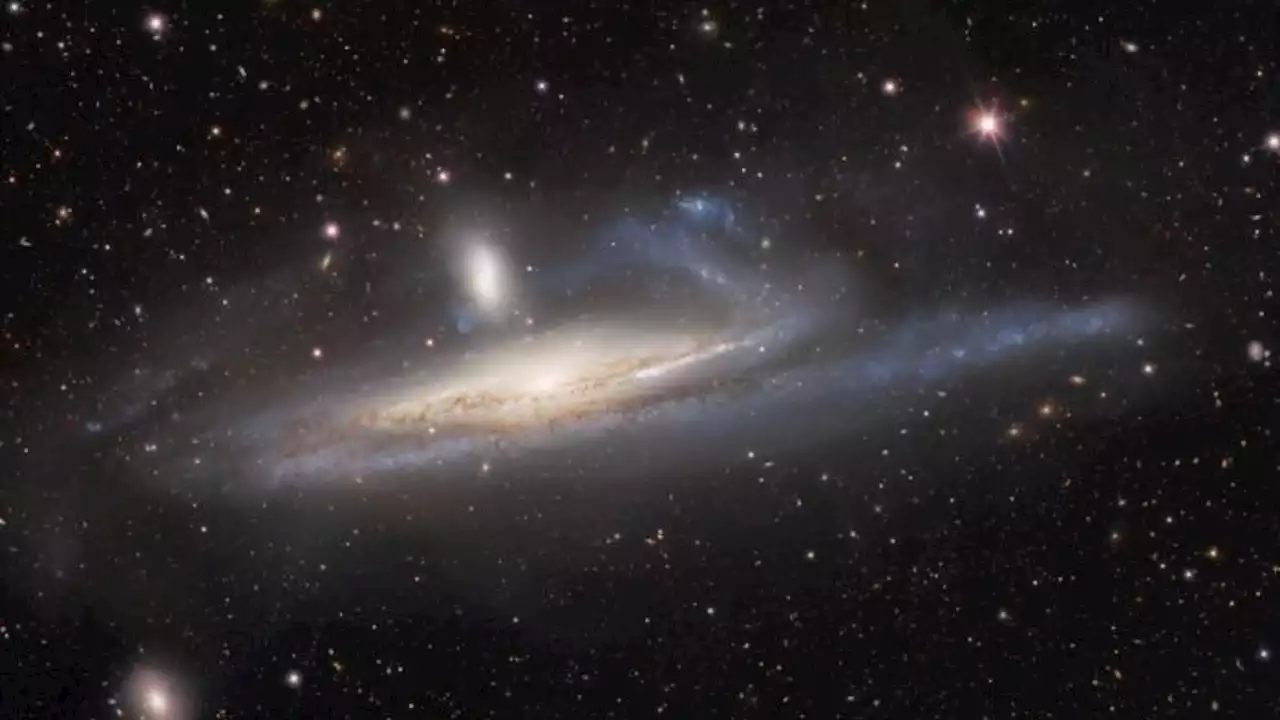 Dark energy camera captures 'cosmic tug of war' between two galaxies