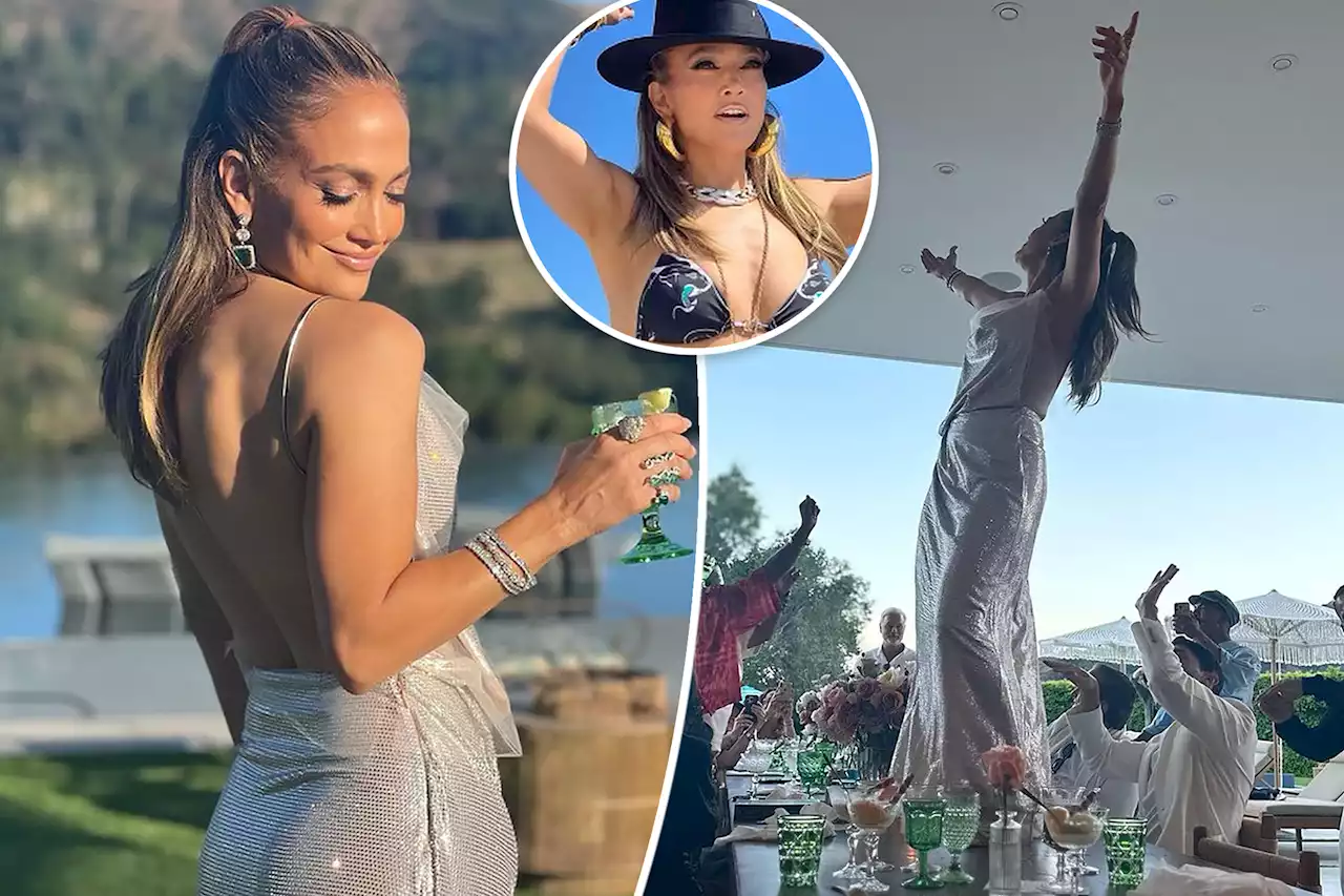 Jennifer Lopez dances on a table in backless metallic look for 54th birthday, shows off bikini bod