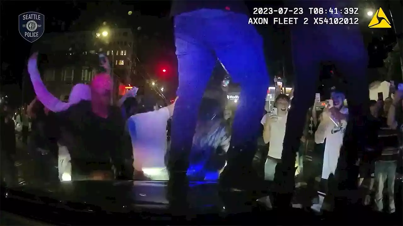 Video shows crowd jumping on hood of police vehicle hours before shooting at illegal street race