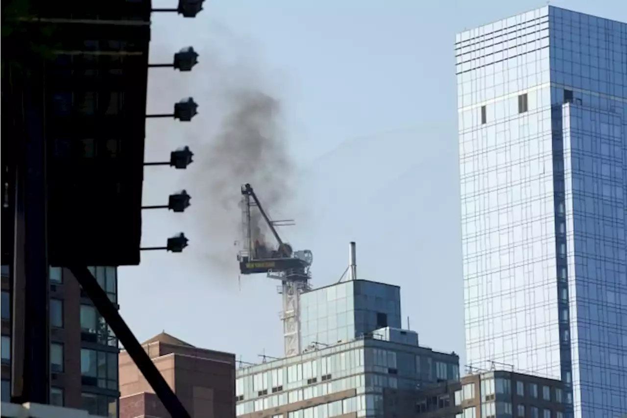 Pedestrians scatter as fire causes New York construction crane's arm to collapse and crash to street