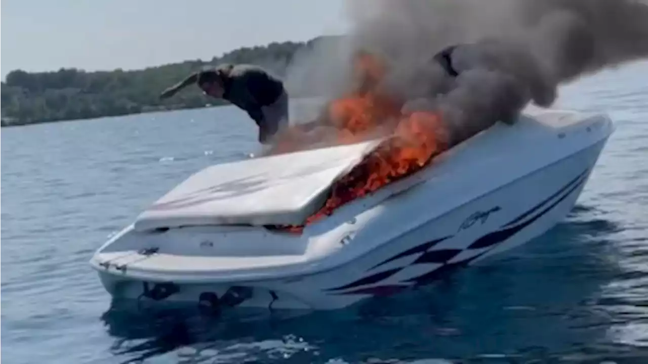 Video captures Michigan boaters diving into water before boat is engulfed in flames