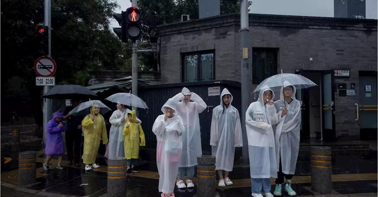 Extreme rain in Beijing after typhoon turns roads into rivers, kills two