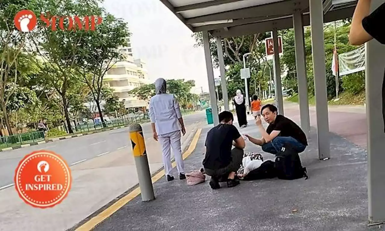 Good Samaritans aid woman lying on ground at Tampines bus stop before she's taken to hospital