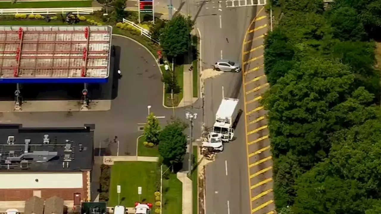 1 killed when garbage truck crashes into school bus, cars stopped at red light in Hauppauge